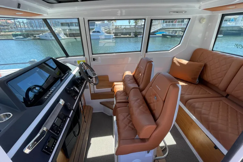 Slide: The Image of Interior of 2022 Axopar Brabus 28 Cabin with luxurious leather seating and modern dashboard. - 30