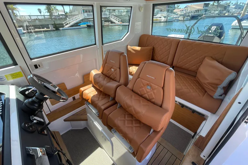 Slide: The Image of Luxurious interior of 2022 Axopar Brabus 28 Cabin with leather seating and waterfront view. - 31