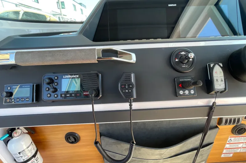 Slide: The Image of Control panel of 2022 Axopar Brabus 28 Cabin with navigation and communication equipment. - 36