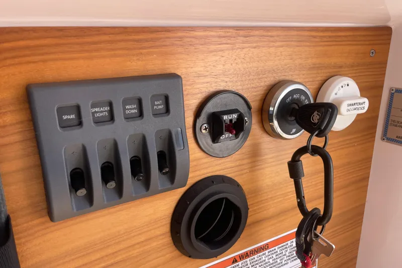 Slide: The Image of Control panel of 2022 Axopar Brabus 28 Cabin with switches and ignition keys. - 38