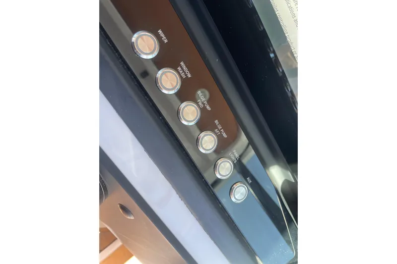 Slide: The Image of Control panel of 2022 Axopar Brabus 28 Cabin with labeled buttons for various functions. - 39