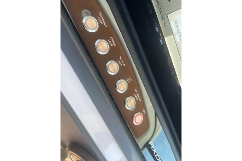 Slide: The Image of Control panel of 2022 Axopar Brabus 28 Cabin with labeled buttons for lights and horn. - 40