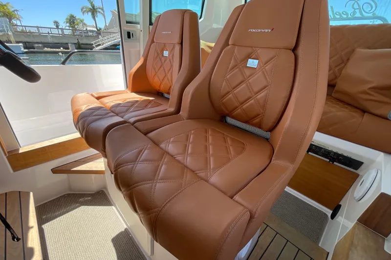 Slide: The Image of Luxurious brown leather seats in 2022 Axopar Brabus 28 Cabin boat interior. - 41