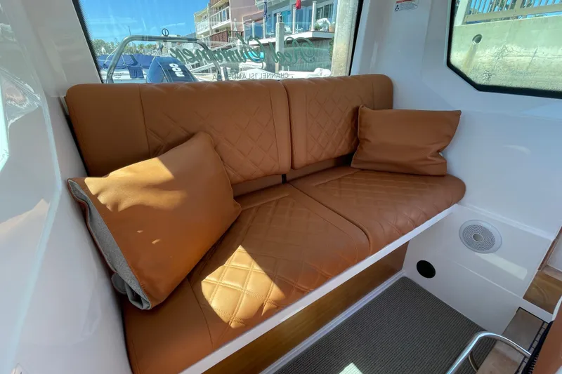 Slide: The Image of Luxurious leather seating inside 2022 Axopar Brabus 28 Cabin boat, featuring quilted design and cushions. - 42