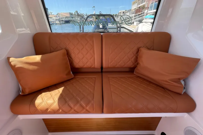 Slide: The Image of Luxurious leather seating inside 2022 Axopar Brabus 28 Cabin boat, featuring quilted design and cushions. - 43