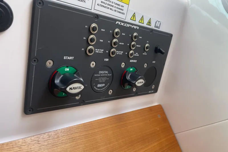Slide: The Image of Control panel of 2022 Axopar Brabus 28 Cabin boat with switches and knobs. - 45
