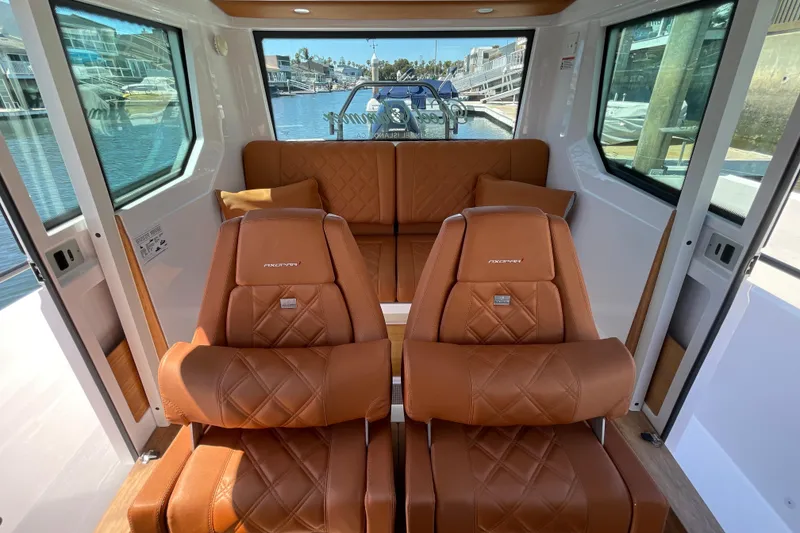 Slide: The Image of Luxurious interior of 2022 Axopar Brabus 28 Cabin with brown leather seating. - 47