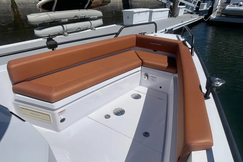 Slide: The Image of 2022 Axopar Brabus 28 Cabin boat with brown seating, docked at marina. - 5