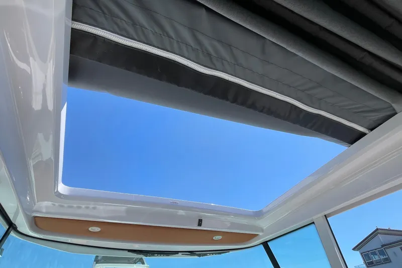 Slide: The Image of Sunroof view from 2022 Axopar Brabus 28 Cabin, showcasing clear blue sky. - 55