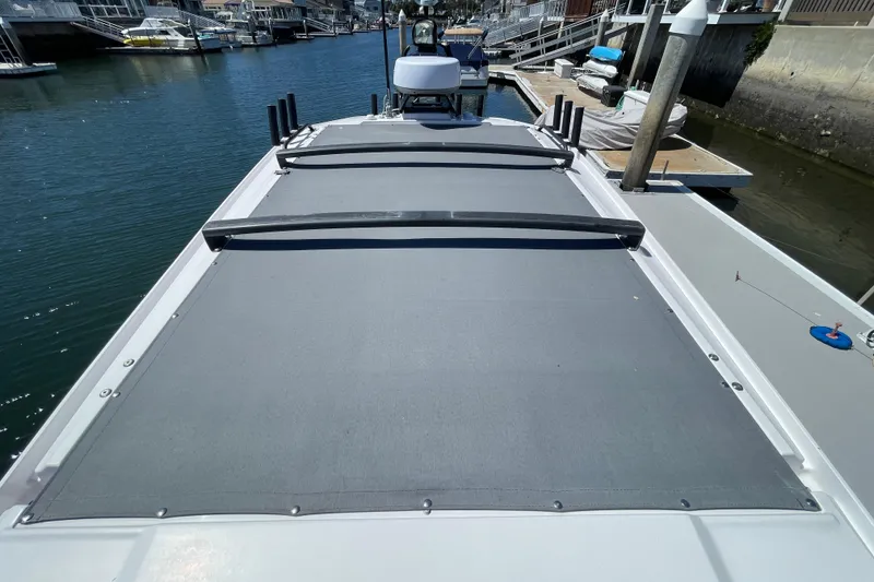 Slide: The Image of 2022 Axopar Brabus 28 Cabin boat docked at marina, showcasing sleek roof design. - 56