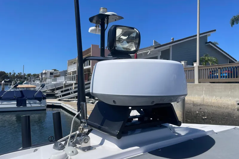 Slide: The Image of 2022 Axopar Brabus 28 Cabin radar system on a sunny marina dock. - 58
