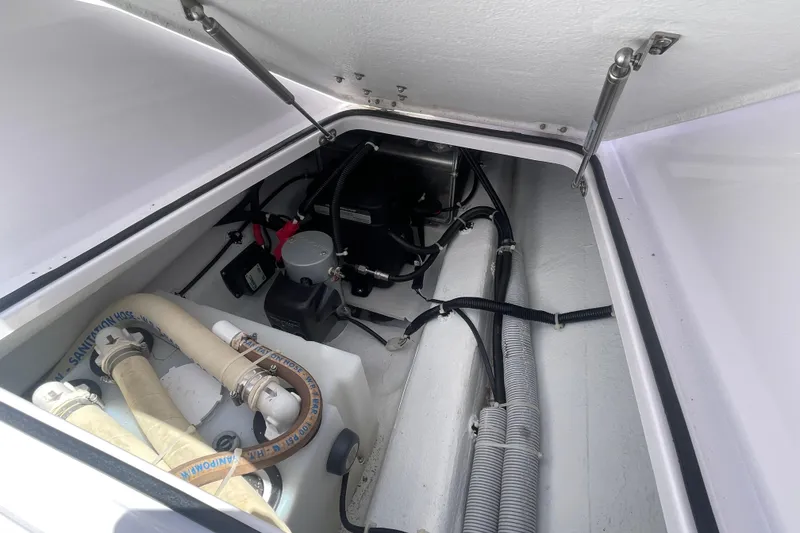 Slide: The Image of 2022 Axopar Brabus 28 Cabin engine compartment with hoses and wiring. - 6