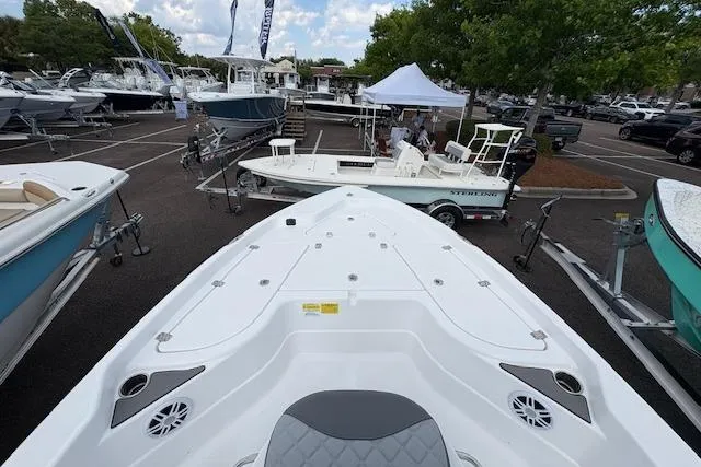 Slide: The Image of 2026 NauticStar 194 Bay boat displayed at a marina with other boats. - 10