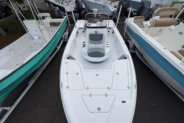 Slide: The Image of 2026 NauticStar 194 Bay boat, white deck, displayed among other boats in a showroom. - 11