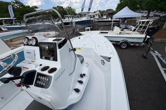Slide: The Image of 2026 NauticStar 194 Bay boat displayed at a marina, showcasing its sleek design and controls. - 13