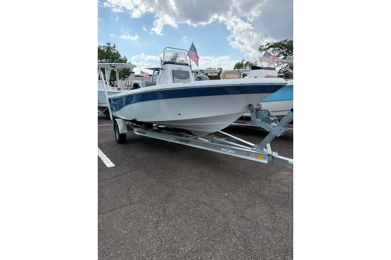 Slide: The Image of 2026 NauticStar 194 Bay boat on trailer, displayed outdoors under cloudy sky. - 2