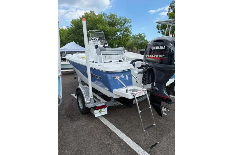 Slide: The Image of 2026 NauticStar 194 Bay boat with Yamaha engine on trailer, parked outdoors. - 3