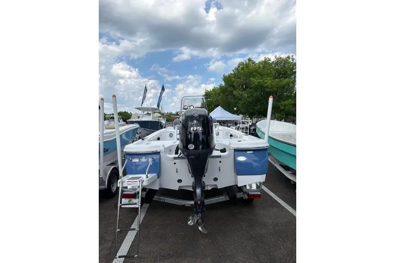 Slide: The Image of 2026 NauticStar 194 Bay boat with 115 HP engine displayed outdoors. - 4