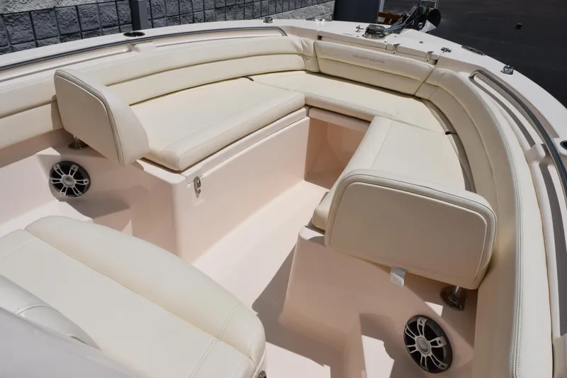 Slide: The Image of 2024 Grady-White Fisherman 236 boat interior with cushioned seating and speakers. - 11