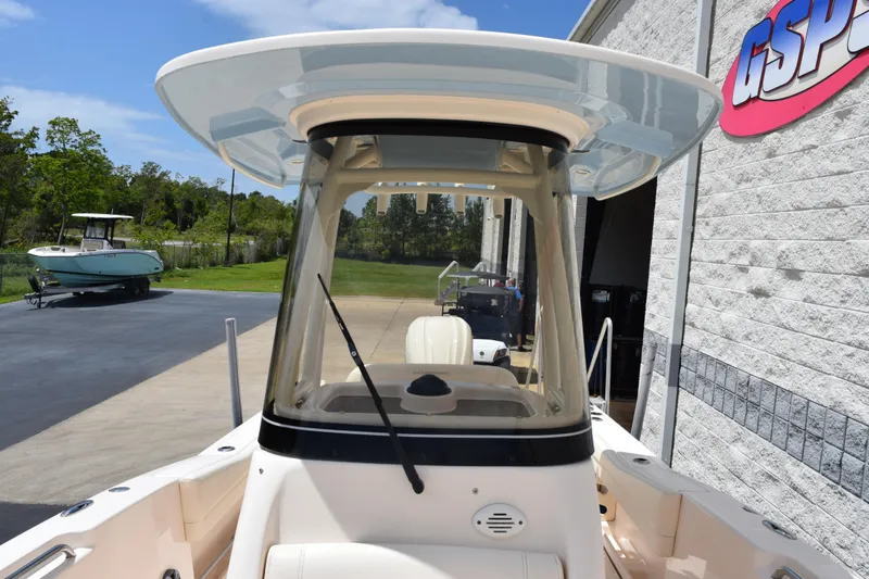 Slide: The Image of 2024 Grady-White Fisherman 236 boat, front view, parked near a building. - 13