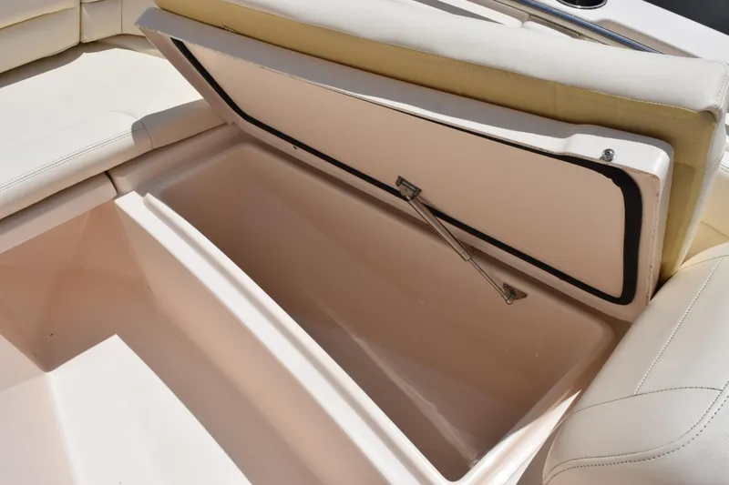 Slide: The Image of 2024 Grady-White Fisherman 236 boat storage compartment with cushioned seating. - 19