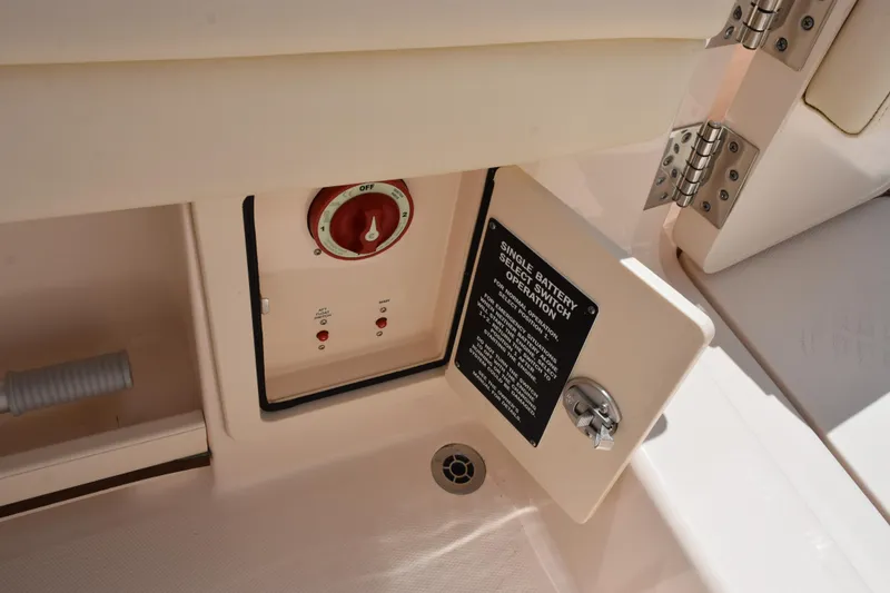 Slide: The Image of 2024 Grady-White Fisherman 236 battery switch compartment with safety instructions. - 21