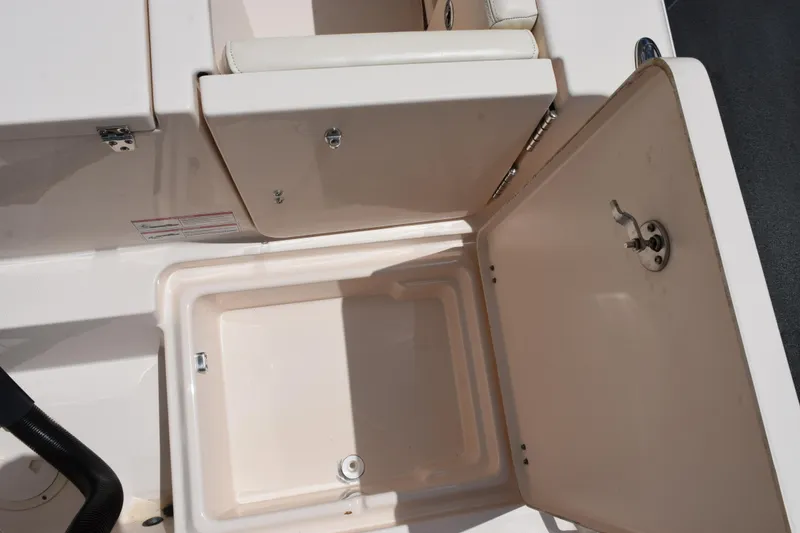 Slide: The Image of 2024 Grady-White Fisherman 236 boat storage compartment with open lid and latch. - 24