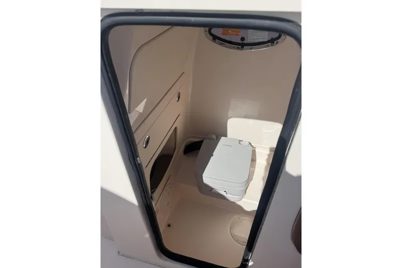 Slide: The Image of 2024 Grady-White Fisherman 236 boat interior with compact marine toilet. - 26