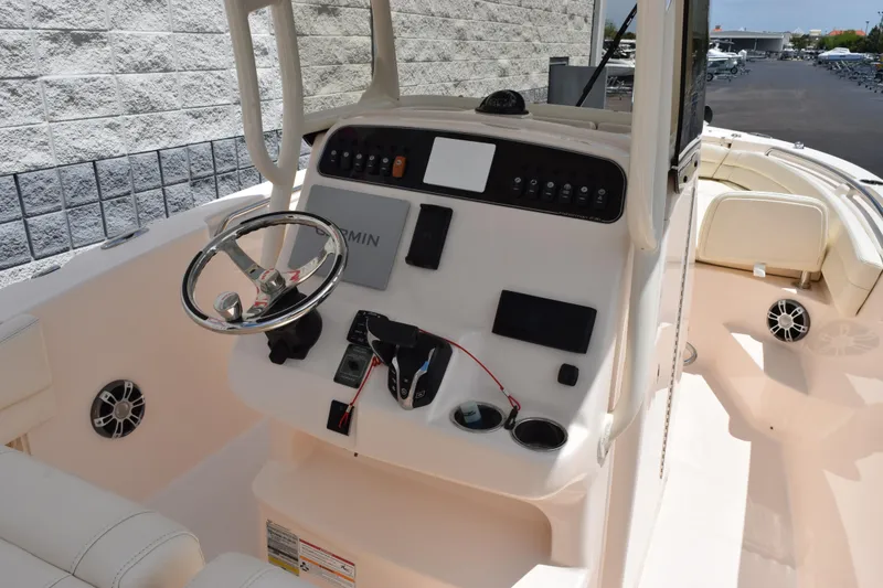 Slide: The Image of 2024 Grady-White Fisherman 236 boat console with steering wheel and controls. - 7
