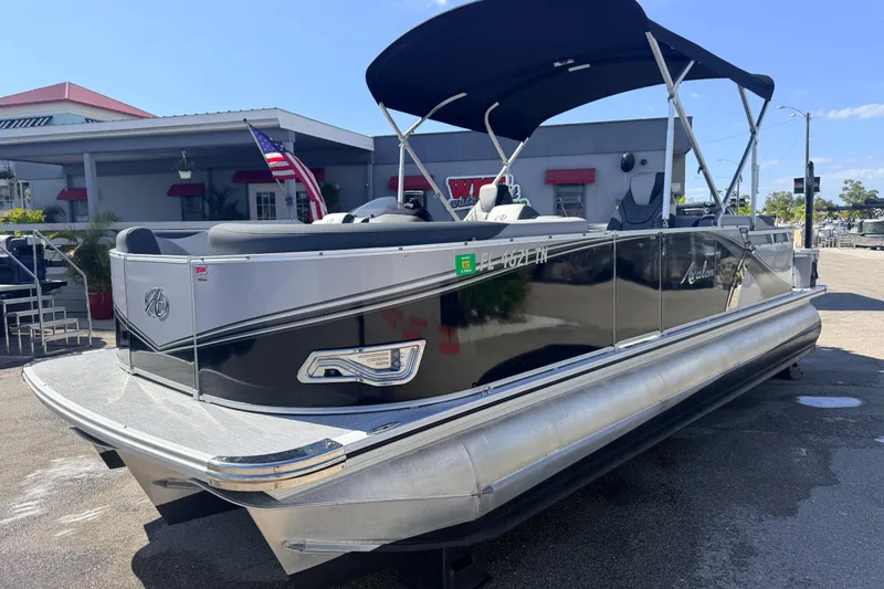 The Image of 2026 Avalon 2485 LSZ Quad Lounger Tri Toon boat with high performance features, docked outdoors. - 0