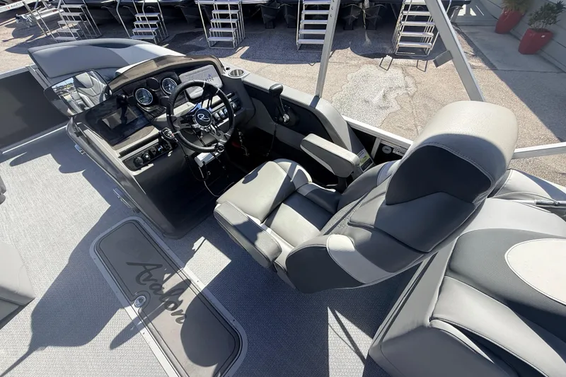 Slide: The Image of 2026 Avalon 2485 LSZ Quad Lounger boat interior with modern helm and comfortable seating. - 15