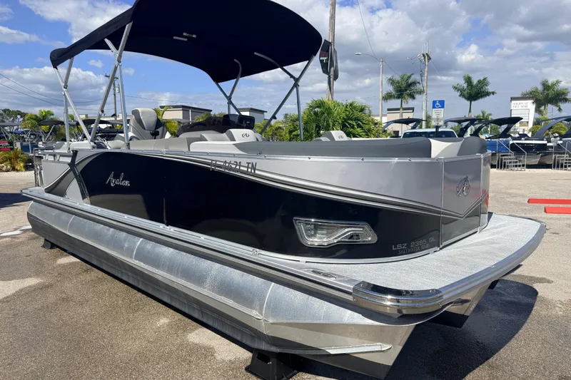 Slide: The Image of 2026 Avalon 2485 LSZ Quad Lounger Tri Toon boat with high performance features, docked outdoors. - 3