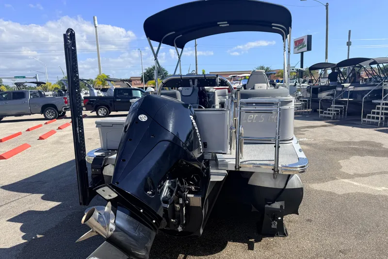 Slide: The Image of 2026 Avalon 2485 LSZ Quad Lounger Tri Toon with high-performance engine, parked outdoors. - 4