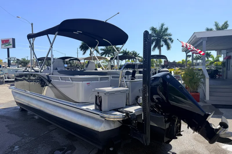 Slide: The Image of 2026 Avalon 2485 LSZ Quad Lounger Tri Toon boat with high performance features, docked outdoors. - 5