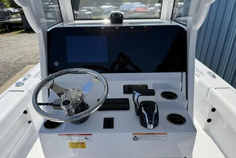 Slide: The Image of 2026 Sportsman Masters 247OE Bay Boat dashboard with steering wheel and controls. - 12