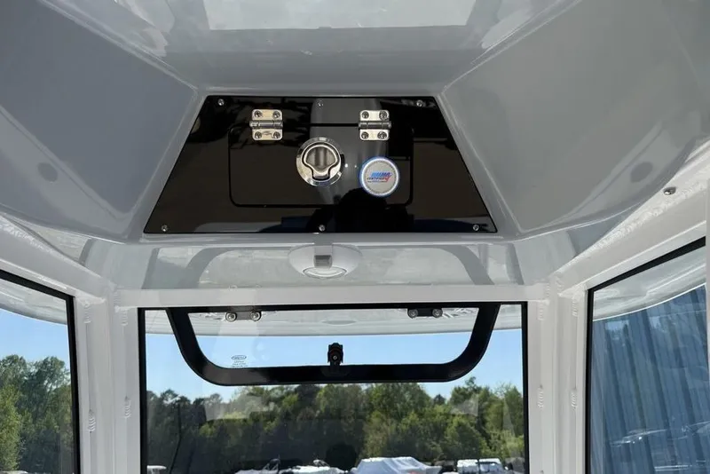 Slide: The Image of Interior view of 2026 Sportsman Masters 247OE Bay Boat console with storage compartment. - 15