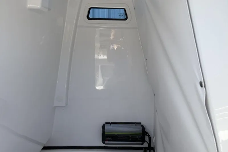 Slide: The Image of Interior view of 2026 Sportsman Masters 247OE Bay Boat cabin with window and equipment. - 18