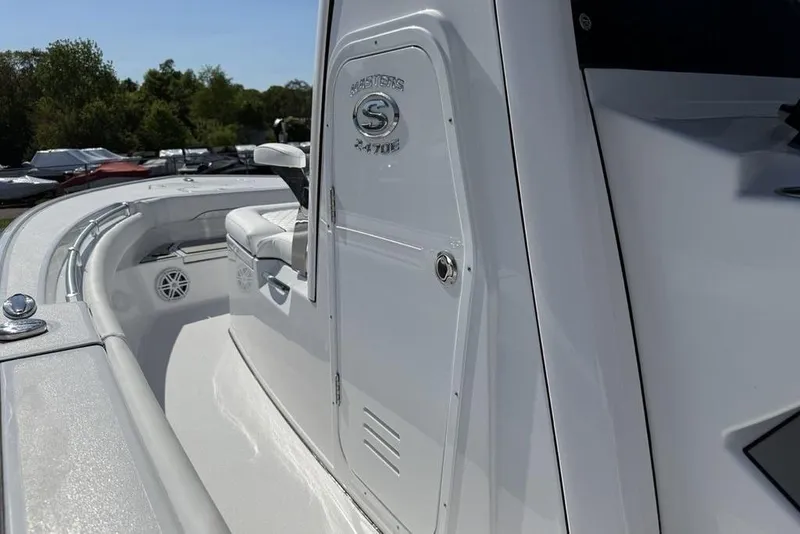 Slide: The Image of 2026 Sportsman Masters 247OE Bay Boat, sleek white design, side view with seating and console. - 22