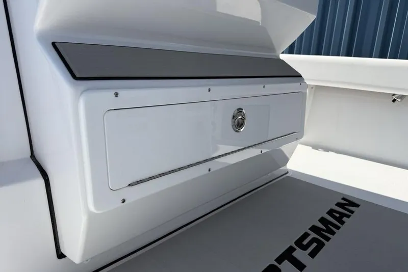 Slide: The Image of 2026 Sportsman Masters 247OE Bay Boat storage compartment with sleek design and secure latch. - 23