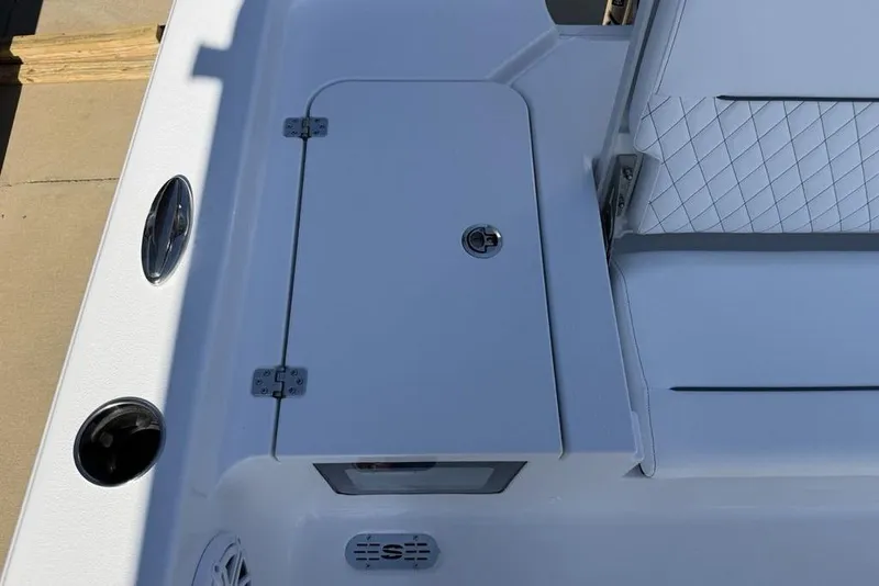 Slide: The Image of 2026 Sportsman Masters 247OE Bay Boat deck with storage compartment and seating. - 24