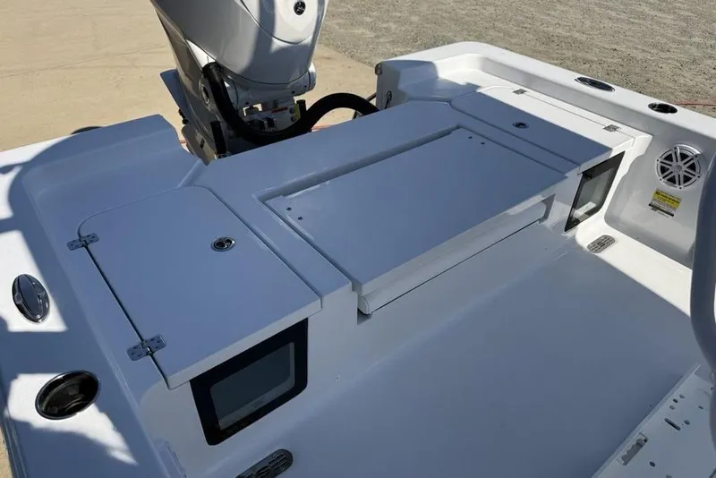 Slide: The Image of 2026 Sportsman Masters 247OE Bay Boat deck with storage compartments and motor. - 26