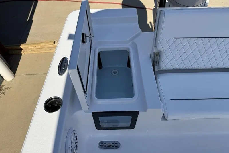 Slide: The Image of 2026 Sportsman Masters 247OE Bay Boat with open storage compartment and seating area. - 27