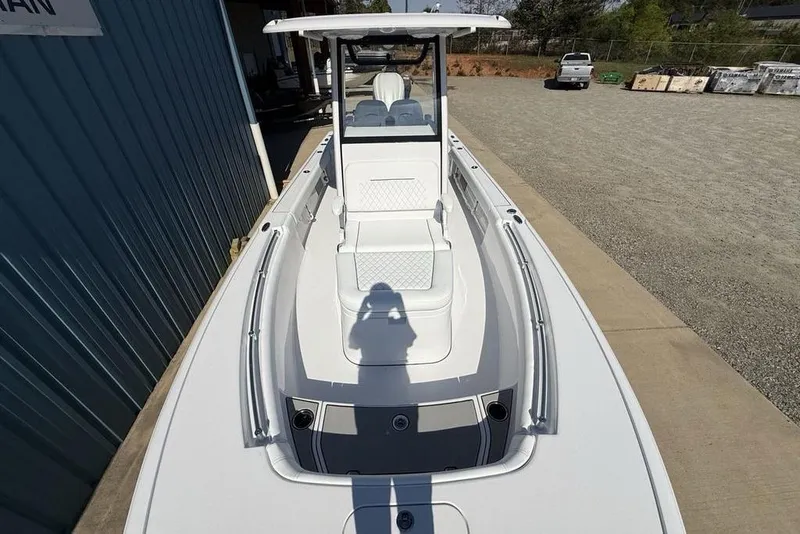 Slide: The Image of 2026 Sportsman Masters 247OE Bay Boat, sleek design, spacious deck, parked outdoors. - 28