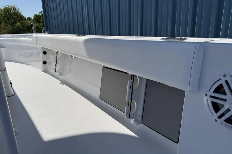 Slide: The Image of 2026 Sportsman Masters 247OE Bay Boat interior detail with storage compartments and speaker. - 29