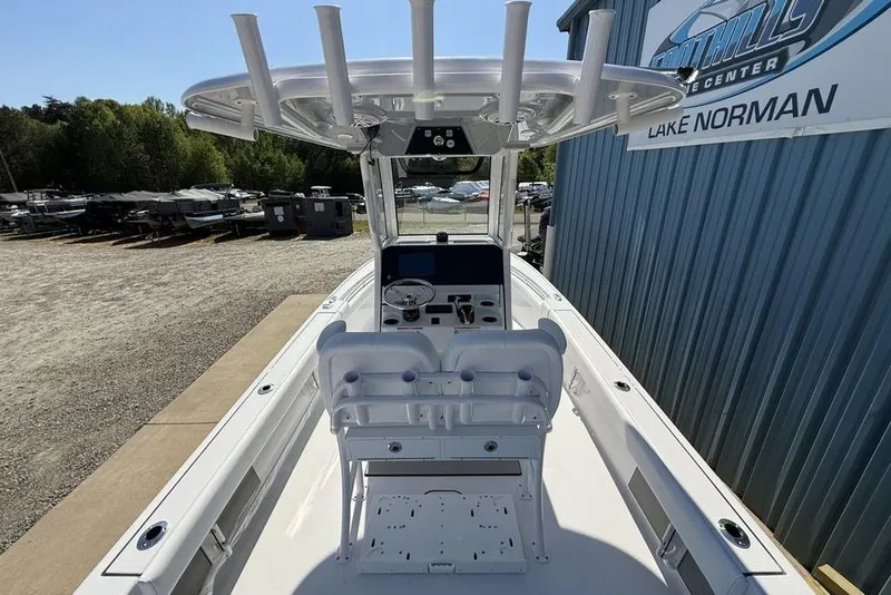 Slide: The Image of 2026 Sportsman Masters 247OE Bay Boat at dealership, showcasing helm and seating area. - 31