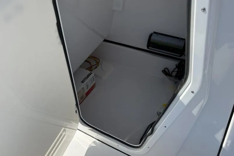 Slide: The Image of Storage compartment of 2026 Sportsman Masters 247OE Bay Boat, featuring electrical components. - 33