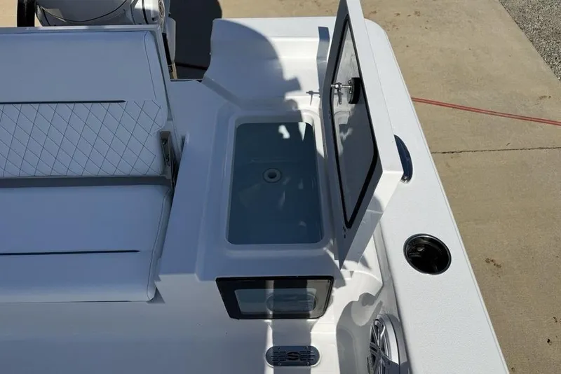 Slide: The Image of 2026 Sportsman Masters 247OE Bay Boat with open storage compartment and seating area. - 34