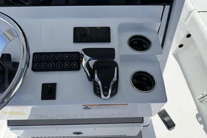 Slide: The Image of Control panel of 2026 Sportsman Masters 247OE Bay Boat with steering wheel and cup holders. - 35