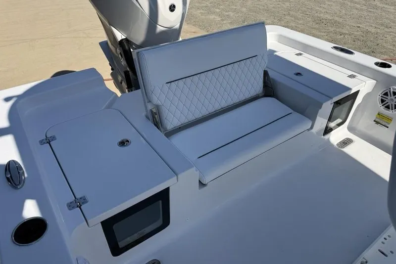 Slide: The Image of 2026 Sportsman Masters 247OE Bay Boat interior with cushioned seating and storage compartments. - 36