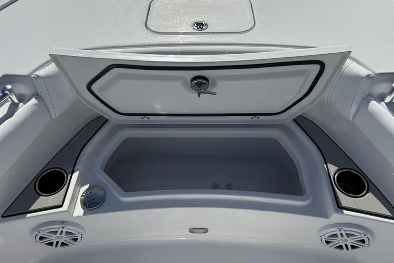 Slide: The Image of 2026 Sportsman Masters 247OE Bay Boat storage compartment with cup holders and speakers. - 7